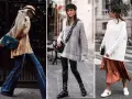 Drei Frauen zeigen, wie man einen **oversize pullover stylen** kann: mit Schlagjeans, Lederhose oder Satinrock.