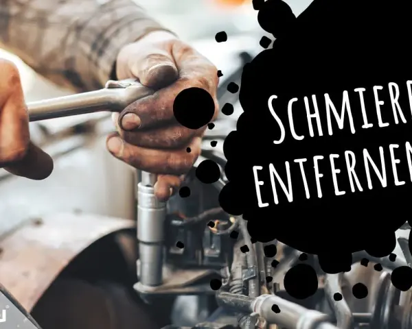 Hände mit Fettflecken reparieren ein Auto. Tipps, wie man Schmierfett aus Kleidung entfernen kann.