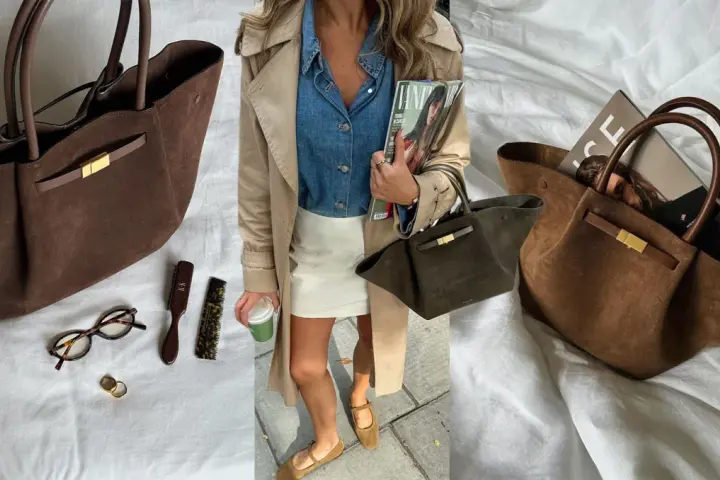 Braune Wildleder Demellier New York Tote mit goldenem Verschluss, daneben Brille, Ringe und Bürsten.