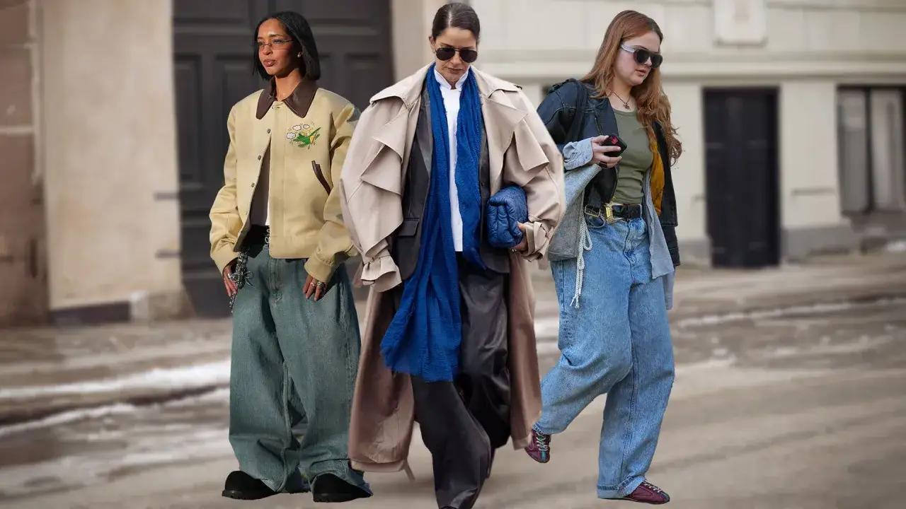 Drei Frauen präsentieren lässige baggy jeans outfits. Eine trägt eine beige Bomberjacke, die andere einen beigen Trenchcoat mit blauer Seide, die dritte eine Lederjacke.
